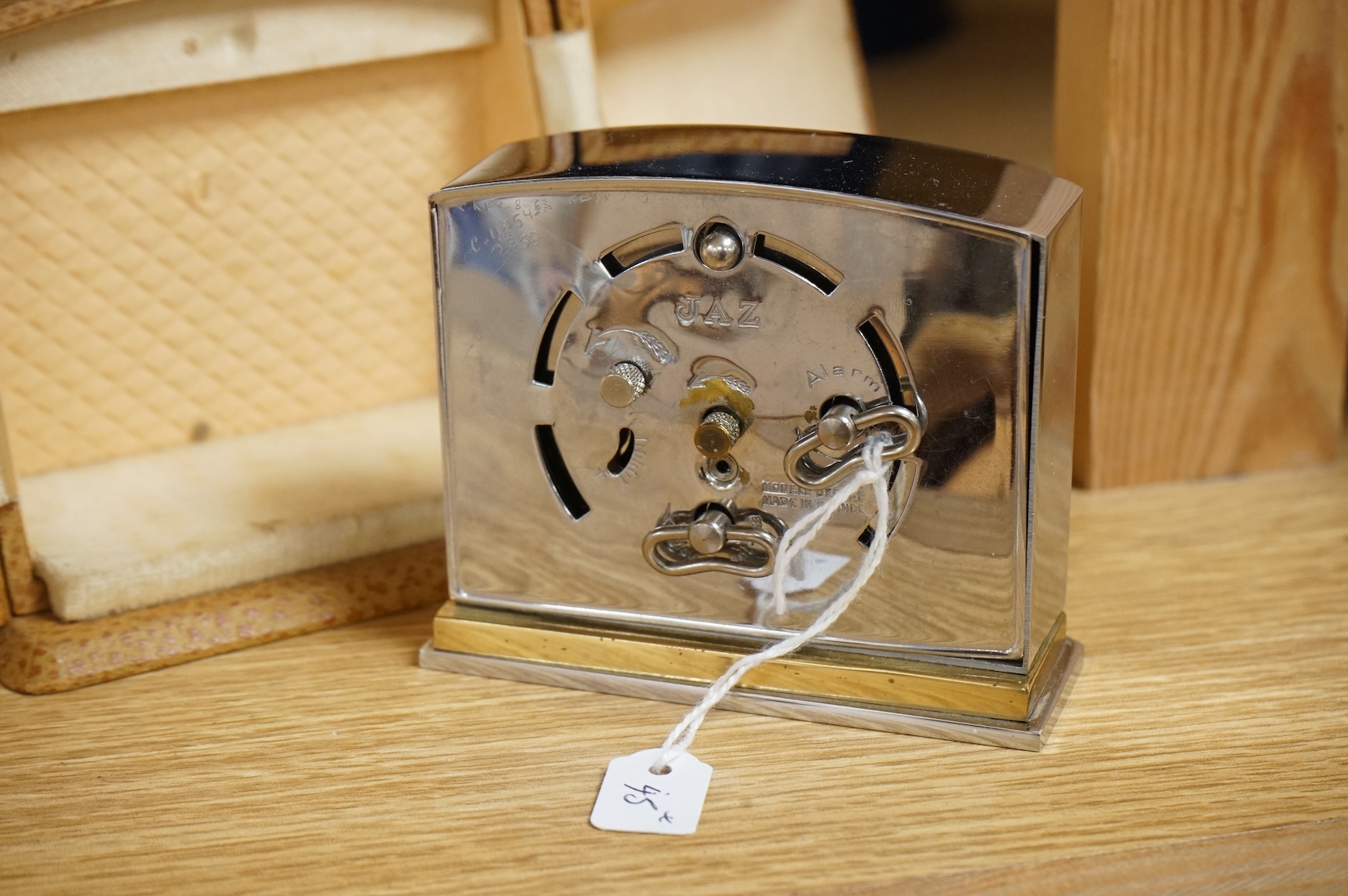 Two Art Deco timepieces comprising a Japy alarm clock and a Jas cased travelling example, largest 22cm wide
